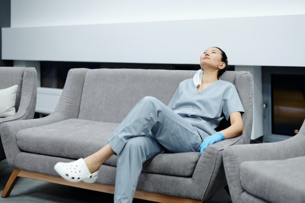 Photo Of Woman Healthcare Worker Resting On The Couch